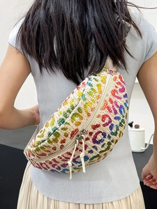 Rainbow woven waist bag with leopard pattern on model, straw texture beach fanny pack