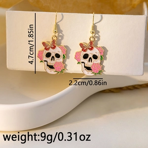 Detail view of skull earrings with dimensions showing 4.7cm height and 2.2cm width