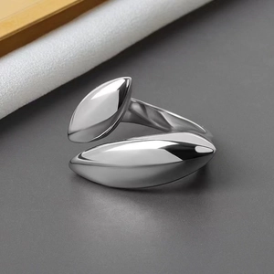 Detailed view of polished silver oval teardrop ring with open geometric design