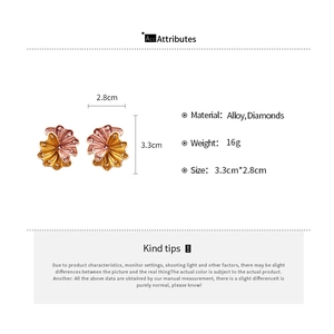 Detail view of retro metal flower earrings with crystal accents and 3.3cm size dimensions