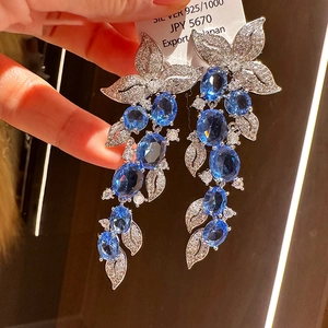 Macro detail of leaf tassel earrings with S925 silver finish and blue zircon stones
