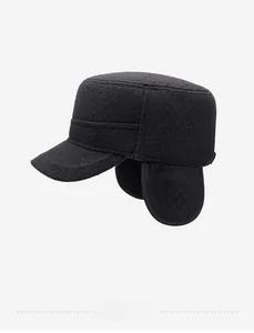 Close-up of warm winter flat cap for men with foldable ear flaps and dark grey wool texture