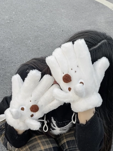 Detail view of plush white cartoon animal gloves with 3D brown pompom and neck strap