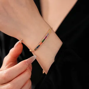 Elegant adjustable gold bracelet featuring vibrant rainbow gradient rectangular zircons