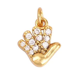 Macro view of gold palm pendant with micro-paved zircons and precise dimensions