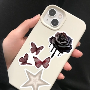 Close-up of off-white phone case with black rose and red butterfly gothic patterns