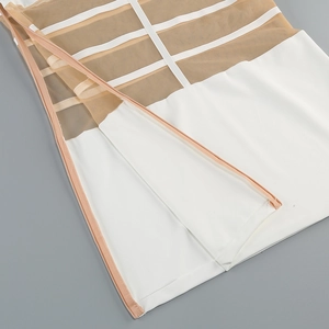 Detail of mesh patchwork design with zipper closure and white decorative tape
