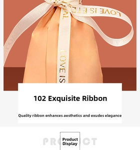 Close-up of champagne satin gift bag with white ribbon featuring gold Love Is Eternal text