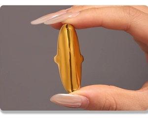 Macro shot of gold irregular oval ring detail showcasing polished stainless steel texture