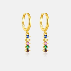 Detail of S925 silver hoop earrings with gradient colored gemstones and polished finish