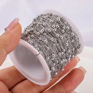 Silver bead cross chain on white spool for DIY jewelry making and necklace crafts