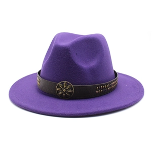 Detail of purple fedora hat featuring a brown leather band and bronze floral metal buckle