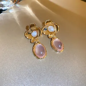 Vintage floral gold earrings with cream pearl center and oval pink resin gemstone pendants