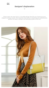 Detail of a color-block tote bag with white and yellow panels and slim leather handles