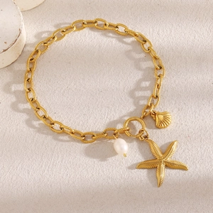 Detailed shot of 18K gold plated starfish and pearl charms on a thick link anklet