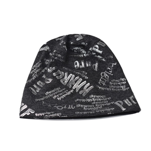 Detailed view of dark grey knitted slouchy beanie with silver foil letter patterns