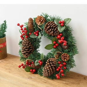 Detail of Christmas wreath with pine cones, red berries and dried orange slices