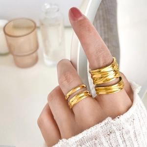 Detail of 18K gold-plated multilayer knotted rings with unique intertwined textures