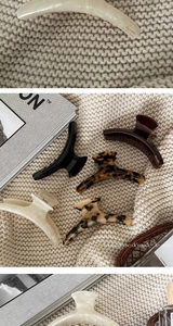 Flat lay of large acetate hair claws in various patterns like tortoiseshell and beige