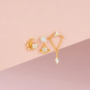 Detailed macro view of S925 silver moon and star earrings with iridescent gemstones