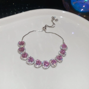 Detail showing pink cubic zirconia heart bracelet with adjustable bolo clasp mechanism