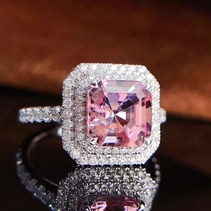 Macro view of luxury square pink zircon ring with dual halo and pave-set diamond band