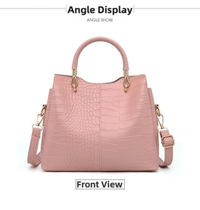 Detail view of pink crocodile pattern handbag with gold hardware and wavy top edge