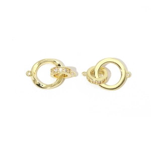 Macro shot of two interlocking gold jewelry clasps with sparkling cubic zirconia pavé