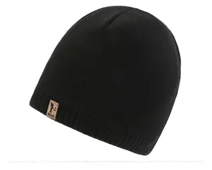 Detail of black winter beanie with brown leather logo patch and tight knit texture