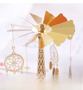 Detailed view of golden electroplated rotary candle holder with dreamcatcher charms and tower base