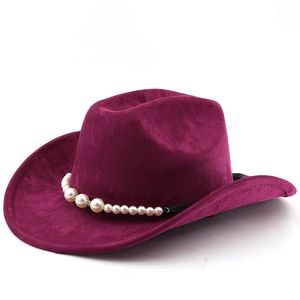Close-up of pearl decorative band on a dark purple suede western cowboy hat crown
