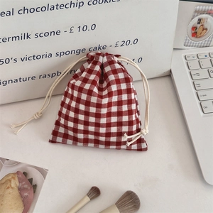 Macro detail of red and white checkered drawstring bag for cosmetics and small accessories