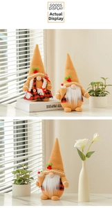 Detail of Christmas gnomes with pointed orange hats and festive red berries decorations