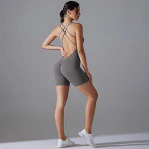 Detail of dark grey yoga bodysuit featuring backless cross straps and athletic fit