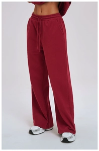 Detail shot of deep red wide-leg sweatpants featuring high elastic drawstring waist