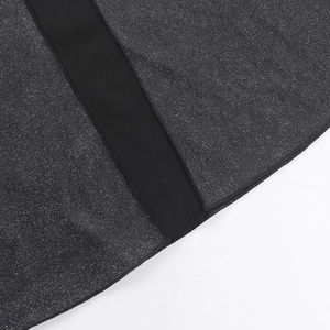 Macro view of black glitter fabric with dense silver sparkles and matte black ribbon detail