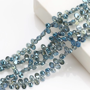 Macro detail of blue crescent glass crystal pendants for DIY earring and jewelry making