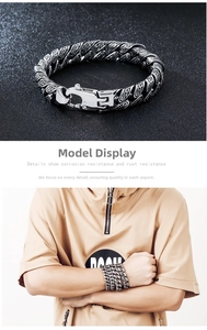 Detailed macro view of retro engraved Cuban link bracelet and model wrist styling