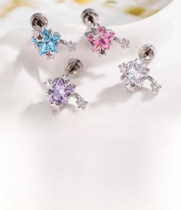 Detailed view of colorful star-shaped cartilidge studs made of titanium steel and zircon