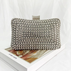 Close-up of a silver rhinestone evening clutch bag with sparkling diamond-studded texture