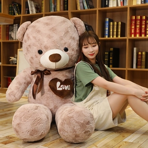 Close-up of a giant light brown teddy bear skin with love heart and silk bow detail