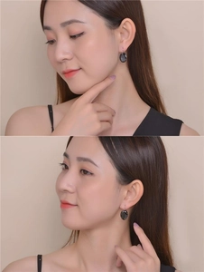 Detail of oval black zircon earrings on model showing elegant minimalist style