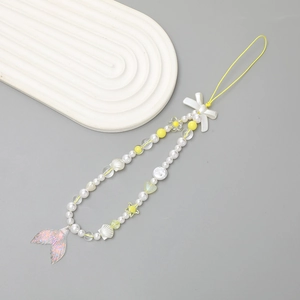 Chic beaded phone strap with white pearls, yellow flowers, and a clear fishtail charm