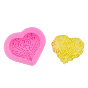 Pink heart silicone mold with intricate floral relief for fondant and chocolate baking