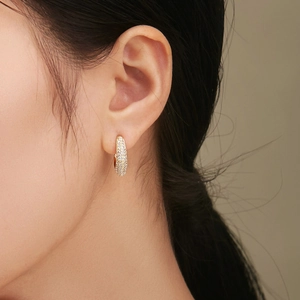 Elegant C-shaped moon curved earrings with sparkling pavé zircons worn by a model