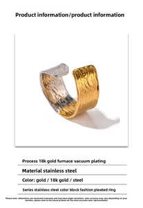 Macro detail of bicolored gold and silver pleated stainless steel ring with wrinkled texture