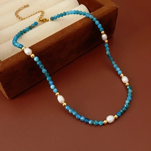 Detail of natural stone necklace with baroque freshwater pearls and gold metal clasp