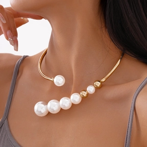 French vintage style gold necklace with asymmetrical pearls on an open metal choker