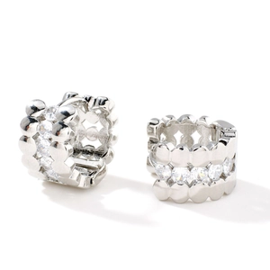 Silver wide hoop earrings with white cubic zirconia and wave edge on white background