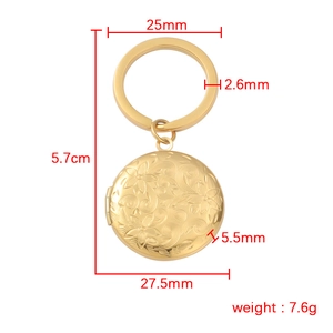 Detailed view of golden locket keychain with floral relief and precise dimensions
